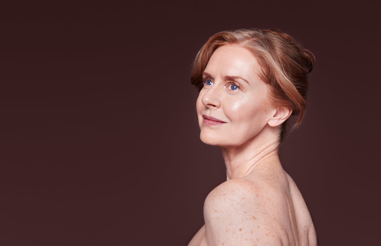 Woman looking over her shoulder with clear skin