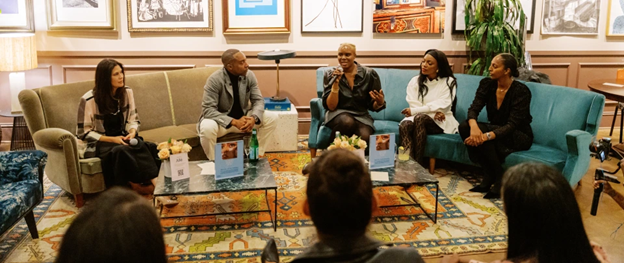African Americans sitting around each other in a meeting conversing