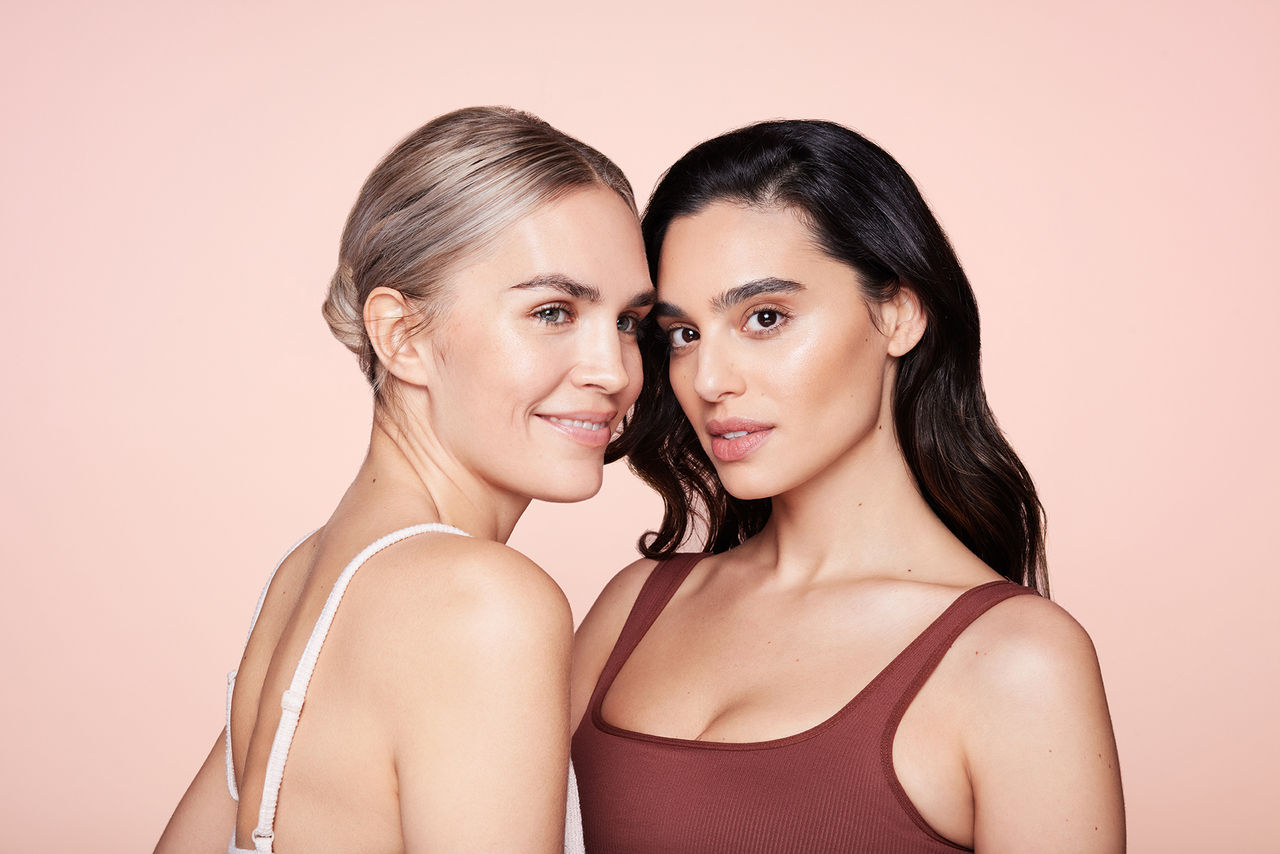 Two women smiling with clear skin