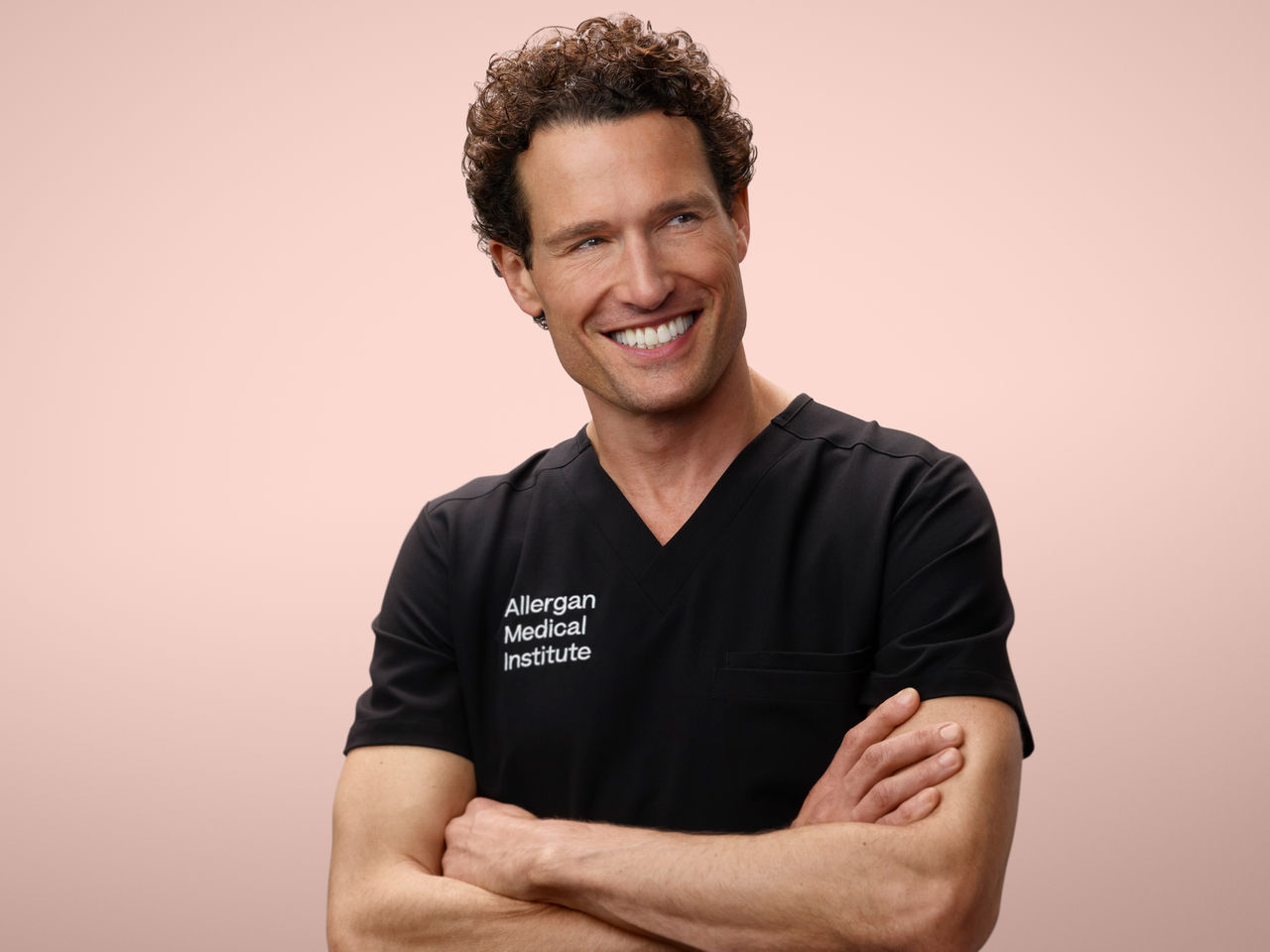 Man with arms folded smiling