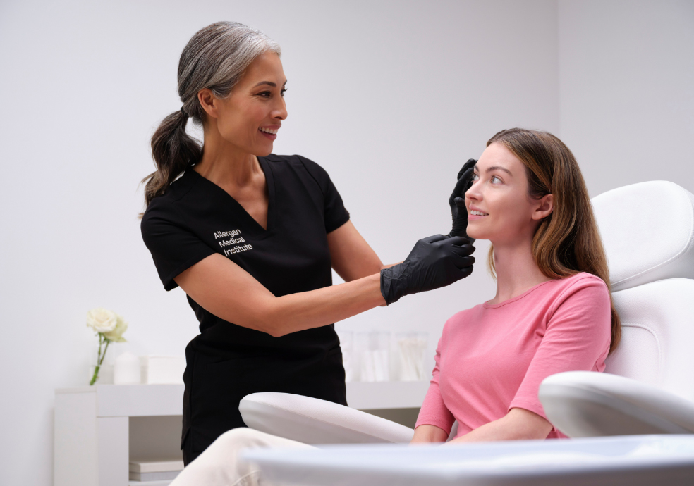 Woman in black top treating a woman in a pink top