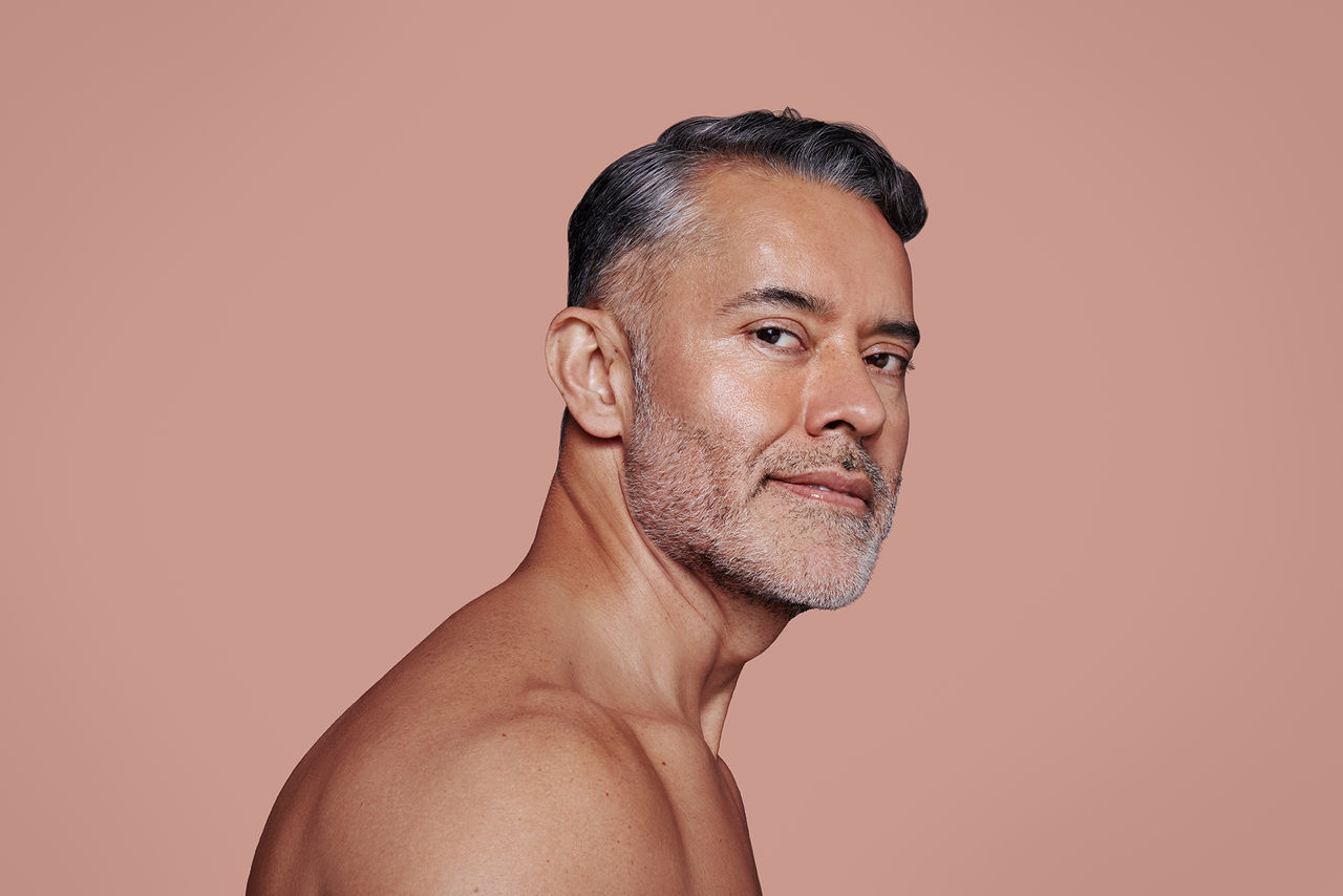 Man smiling with smooth facial features